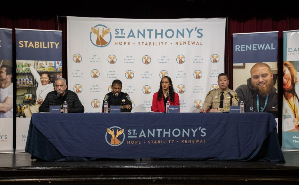 Tom Wolf, Police Chief William Scott, DA Brooke Jenkins, and Sheriff Paul Miyamoto sit on a panel at a public safety town hall hosted by St. Anthony's