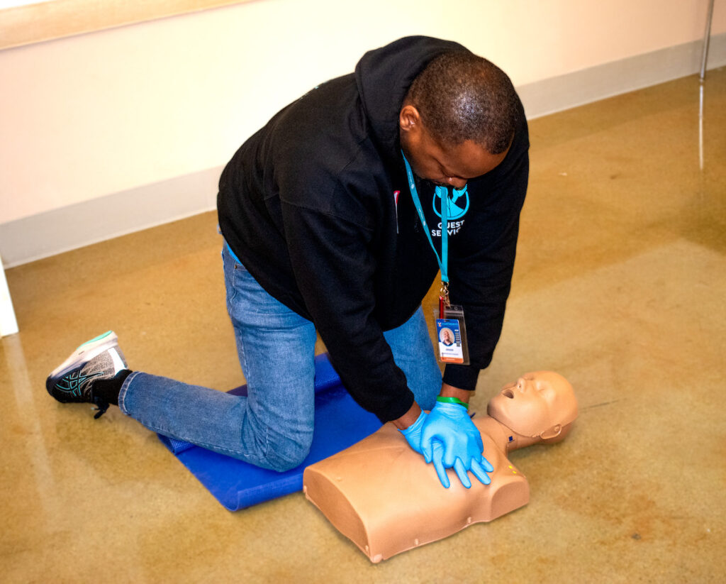 Jessie practices CPR on a test dummy