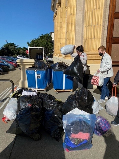 St. Ignatius parishioners load of bins with Free Clothing Program donations