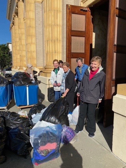 St. Ignatius parishioners pose with Free Clothing Program donations