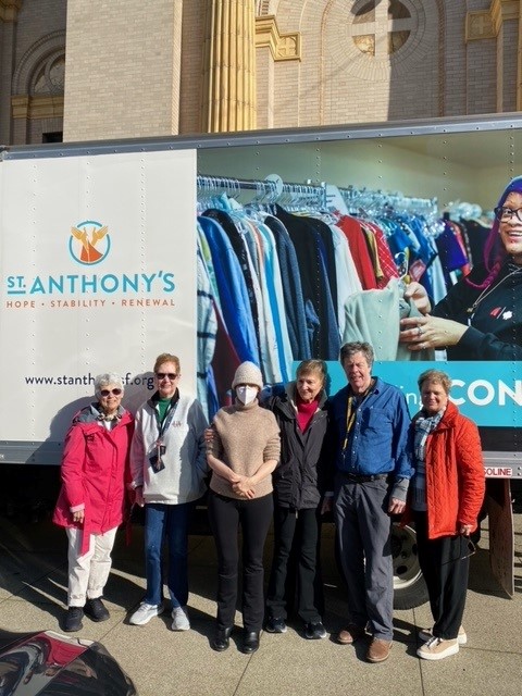 St. Ignatius parishioners pose in front of St. Anthony's Free Clothing Program truck 