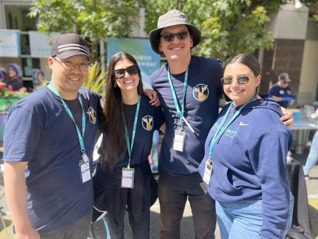 St. Anthony's employees pose and smile at Sunday Streets