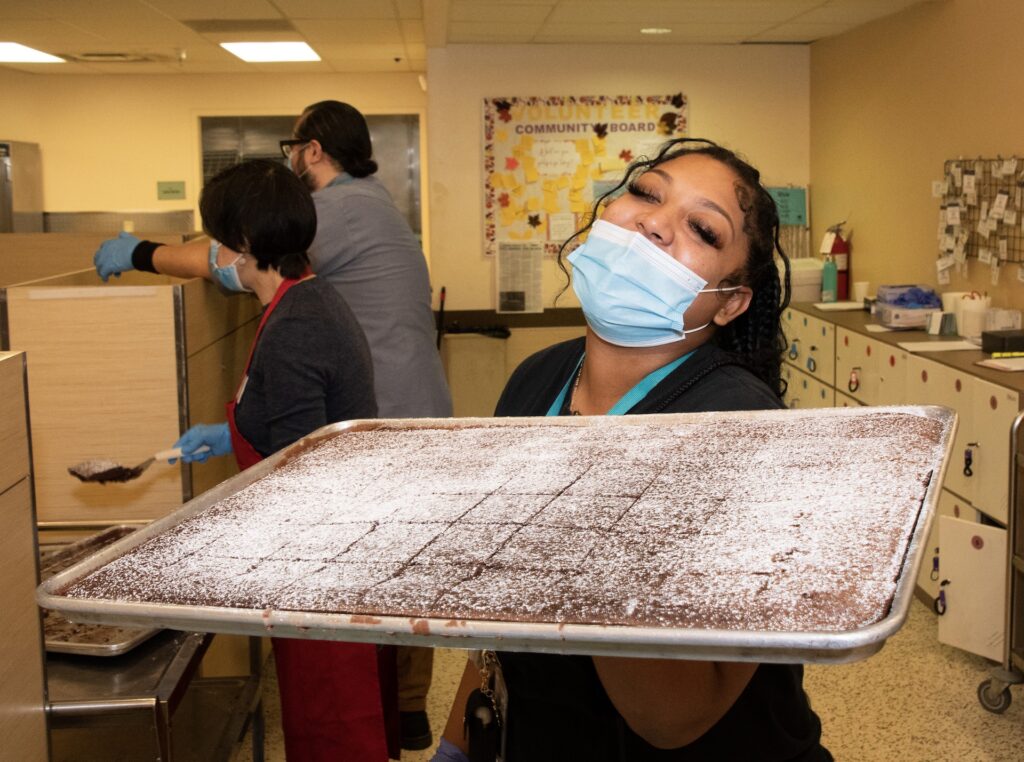 St. Anthony's Team Member Shows off a Tray of Brownies